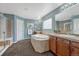 Relaxing bathroom with a soaking tub, separate shower, dual sinks, and updated fixtures at 22965 Allendale Ave, Parker, CO 80138