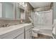 Modern bathroom with double sinks, stylish vanity, and a shower-tub combo with a glass door at 22965 Allendale Ave, Parker, CO 80138