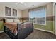 Comfortable bedroom with a queen-size bed, neutral colors, and a large window for natural light at 22965 Allendale Ave, Parker, CO 80138