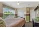 Cozy bedroom with a large window providing natural light, closet doors, and neutral-colored walls at 22965 Allendale Ave, Parker, CO 80138