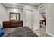 A cozy bedroom features wood-look flooring, closet space, and a dark wood dresser with a beveled mirror at 22965 Allendale Ave, Parker, CO 80138