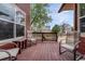 Relax on this wood deck with comfortable seating, offering views of the fenced backyard and neighborhood at 22965 Allendale Ave, Parker, CO 80138