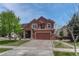 Charming two-story home featuring a two-car garage, well-manicured lawn, and inviting front porch at 22965 Allendale Ave, Parker, CO 80138