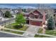 Charming two-story home with a large front yard and an attached two-car garage at 22965 Allendale Ave, Parker, CO 80138