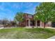 Beautiful front exterior showcasing lush green lawn and manicured landscaping on a sunny day at 22965 Allendale Ave, Parker, CO 80138
