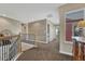 Spacious upstairs hallway featuring wood and iron railings and a convenient laundry closet at 22965 Allendale Ave, Parker, CO 80138