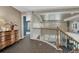 Bright upstairs hallway with an open view of the lower level and a stylish dresser at 22965 Allendale Ave, Parker, CO 80138
