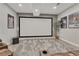 Home theater features a projector screen, mounted speakers, and cozy seating for immersive entertainment at 22965 Allendale Ave, Parker, CO 80138