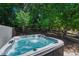 Relaxing hot tub surrounded by mature trees and landscaping at 22965 Allendale Ave, Parker, CO 80138