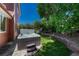 Backyard spa with stone surround and two steps for access on a manicured lawn at 22965 Allendale Ave, Parker, CO 80138