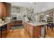 Open concept kitchen with island, view to the living room, and a grand staircase at 22965 Allendale Ave, Parker, CO 80138