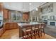 Bright kitchen featuring a large island with seating, modern appliances, and hardwood floors at 22965 Allendale Ave, Parker, CO 80138