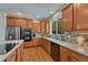 Well-lit kitchen featuring wooden cabinets, stainless steel appliances, and beautiful backsplash at 22965 Allendale Ave, Parker, CO 80138