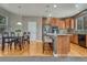 Bright kitchen with a dining area, large island, stainless steel appliances, and hardwood floors at 22965 Allendale Ave, Parker, CO 80138