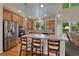 Modern kitchen featuring stainless steel appliances, a center island with seating, and wood flooring at 22965 Allendale Ave, Parker, CO 80138