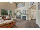 Spacious living room with high ceilings, a fireplace, and large windows providing natural light at 22965 Allendale Ave, Parker, CO 80138