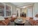 Comfortable living room showcasing neutral walls, wood floors, and furniture, leading into a dining area at 22965 Allendale Ave, Parker, CO 80138