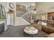 Living room features a grand staircase, open concept floor plan, and a sectional sofa at 22965 Allendale Ave, Parker, CO 80138