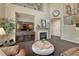 Cozy living room with fireplace, TV, and an ottoman with stairway visible beyond at 22965 Allendale Ave, Parker, CO 80138