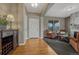 Cozy living room with wood floors, neutral walls and furniture, and a fireplace at 22965 Allendale Ave, Parker, CO 80138