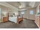 Spacious main bedroom featuring a tray ceiling, updated light fixtures, and a cozy seating area at 22965 Allendale Ave, Parker, CO 80138