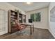Home office with built-in bookshelves, a desk, and a comfortable leather chair at 22965 Allendale Ave, Parker, CO 80138