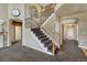 Elegant staircase with iron railings, wooden steps, and an open foyer at 22965 Allendale Ave, Parker, CO 80138