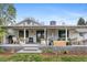 Spacious back porch with outdoor seating, dining, string lights and manicured landscaping at 5965 S Gaylord Way, Greenwood Village, CO 80121