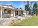 View of the back porch with patio, string lights, yard and play equipment at 5965 S Gaylord Way, Greenwood Village, CO 80121