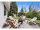 Backyard features an outdoor lounge, play area, mature trees and grass at 5965 S Gaylord Way, Greenwood Village, CO 80121