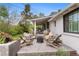 Backyard features an outdoor lounge, a covered porch and mature trees at 5965 S Gaylord Way, Greenwood Village, CO 80121