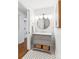 Bathroom featuring a stylish vanity with a round mirror and modern lighting at 5965 S Gaylord Way, Greenwood Village, CO 80121
