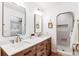 Bathroom with a double sink vanity with quartz countertops and wood cabinets and access to the shower at 5965 S Gaylord Way, Greenwood Village, CO 80121