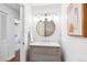 Bathroom featuring a stylish vanity with a round mirror and modern lighting at 5965 S Gaylord Way, Greenwood Village, CO 80121