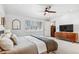 Bright bedroom featuring a ceiling fan, light hardwood floors, and a large window at 5965 S Gaylord Way, Greenwood Village, CO 80121