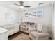 Bedroom with a crib, chair, ceiling fan, and lots of natural light at 5965 S Gaylord Way, Greenwood Village, CO 80121