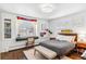 Bright bedroom featuring large window with shutters, desk, and a cozy bench at the foot of the bed at 5965 S Gaylord Way, Greenwood Village, CO 80121