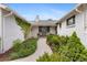 Inviting front entrance with white brick, manicured landscaping, and a welcoming bench at 5965 S Gaylord Way, Greenwood Village, CO 80121