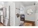 Bright entryway leading to a living space, showing a mirror, coat rack, and stainless steel fridge at 5965 S Gaylord Way, Greenwood Village, CO 80121