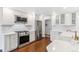 Modern kitchen featuring stainless steel appliances, white cabinetry, and quartz countertops at 5965 S Gaylord Way, Greenwood Village, CO 80121