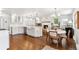 Open-concept kitchen with modern appliances, dining area, and hardwood floors throughout at 5965 S Gaylord Way, Greenwood Village, CO 80121
