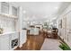 Open kitchen with white cabinets, hardwood floors, and view to dining area with seating at 5965 S Gaylord Way, Greenwood Village, CO 80121
