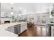 Bright kitchen with white cabinets, large island, stainless steel appliances, and hardwood floors at 5965 S Gaylord Way, Greenwood Village, CO 80121