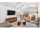 Bright living room with beamed ceilings, modern furniture, and hardwood floors at 5965 S Gaylord Way, Greenwood Village, CO 80121
