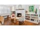 Cozy living room featuring a fireplace, built-in shelves, and ample natural light at 5965 S Gaylord Way, Greenwood Village, CO 80121