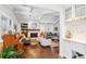 Bright living room with hardwood floors, piano, fireplace, beamed ceiling and bar area at 5965 S Gaylord Way, Greenwood Village, CO 80121