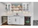 Basement bar with granite countertop, wine fridge, and shelving at 11960 S Allerton Cir, Parker, CO 80138