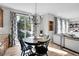 Charming dining area with round wooden table and chandelier at 11960 S Allerton Cir, Parker, CO 80138