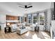 Light-filled living room with sectional sofa and hardwood floors at 11960 S Allerton Cir, Parker, CO 80138