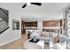 Open living room showcasing a spacious sectional sofa and hardwood floors at 11960 S Allerton Cir, Parker, CO 80138